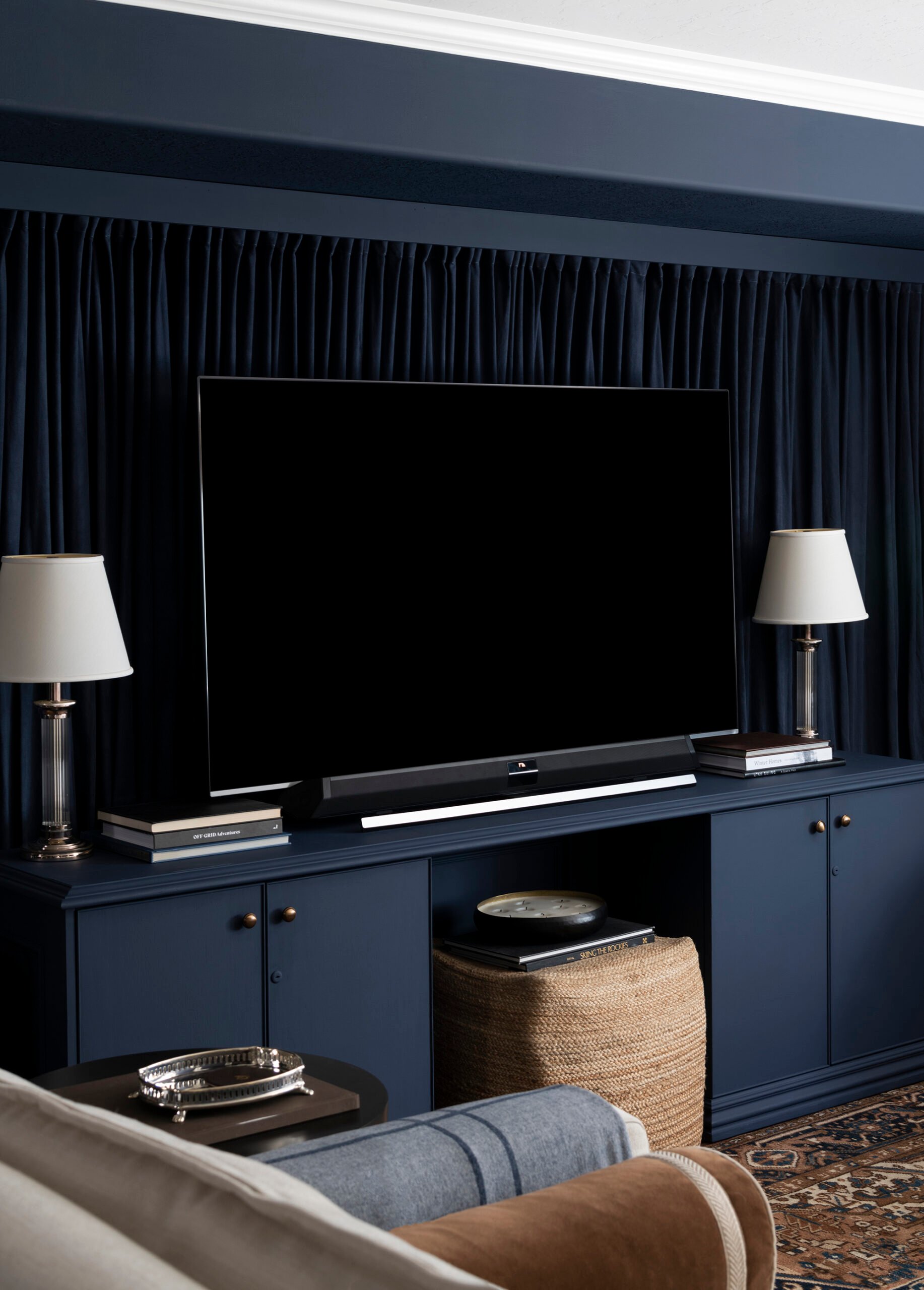 Basement Media Room with Monochromatic Navy Curtain Wall
