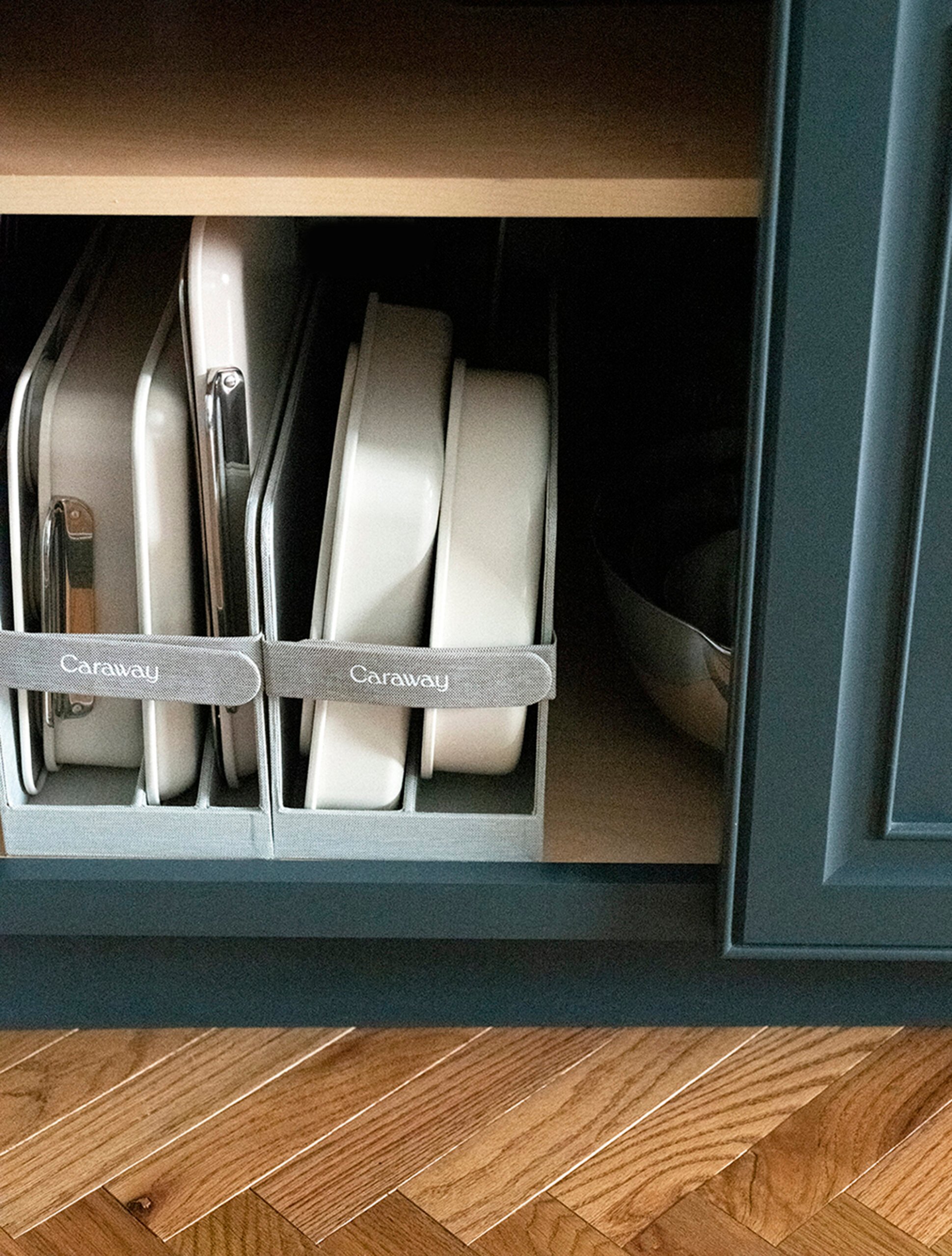 Neatly organized Caraway bakeware sets in kitchen cabinet