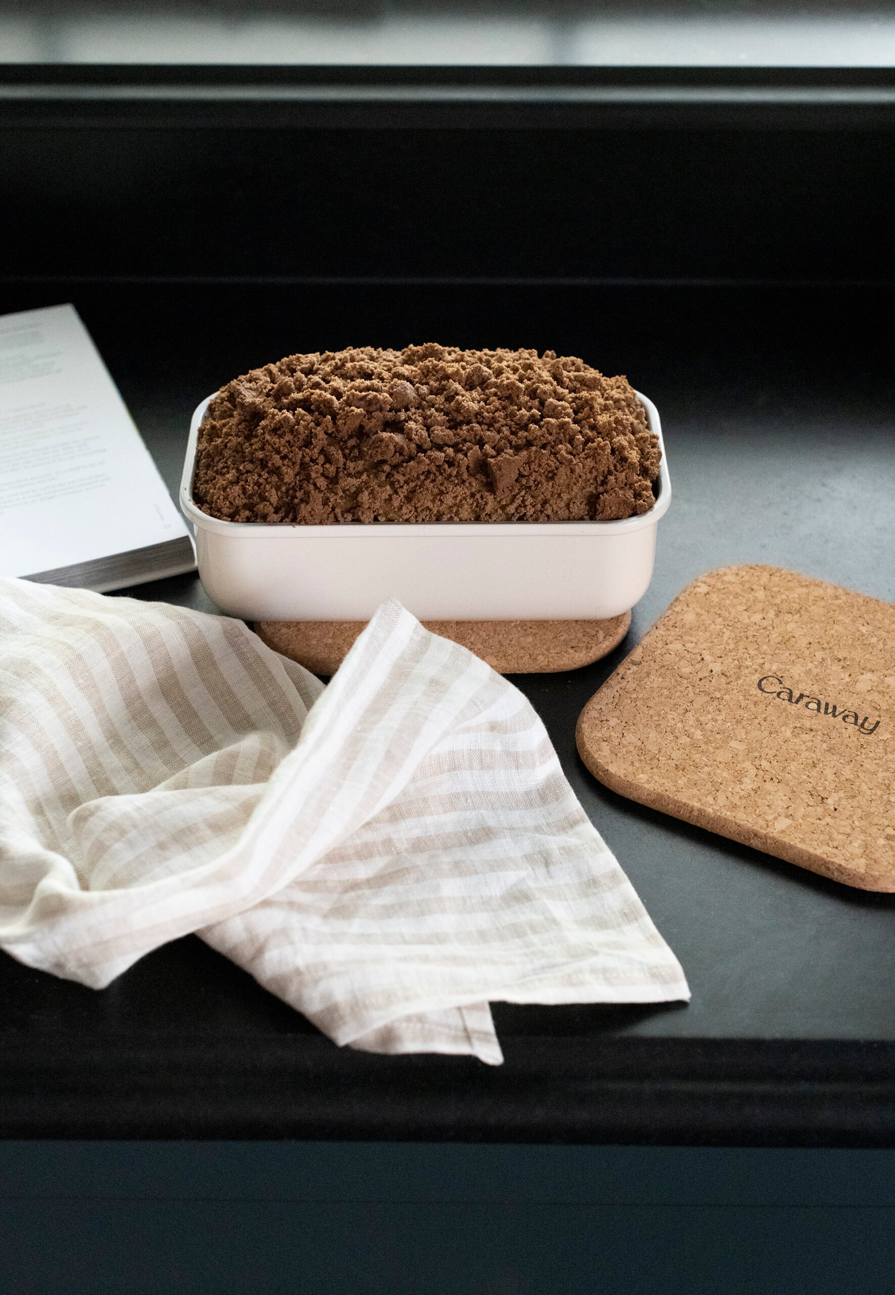 Coffee cake on kitchen counter in Caraway loaf pan with a linen kitchen towel