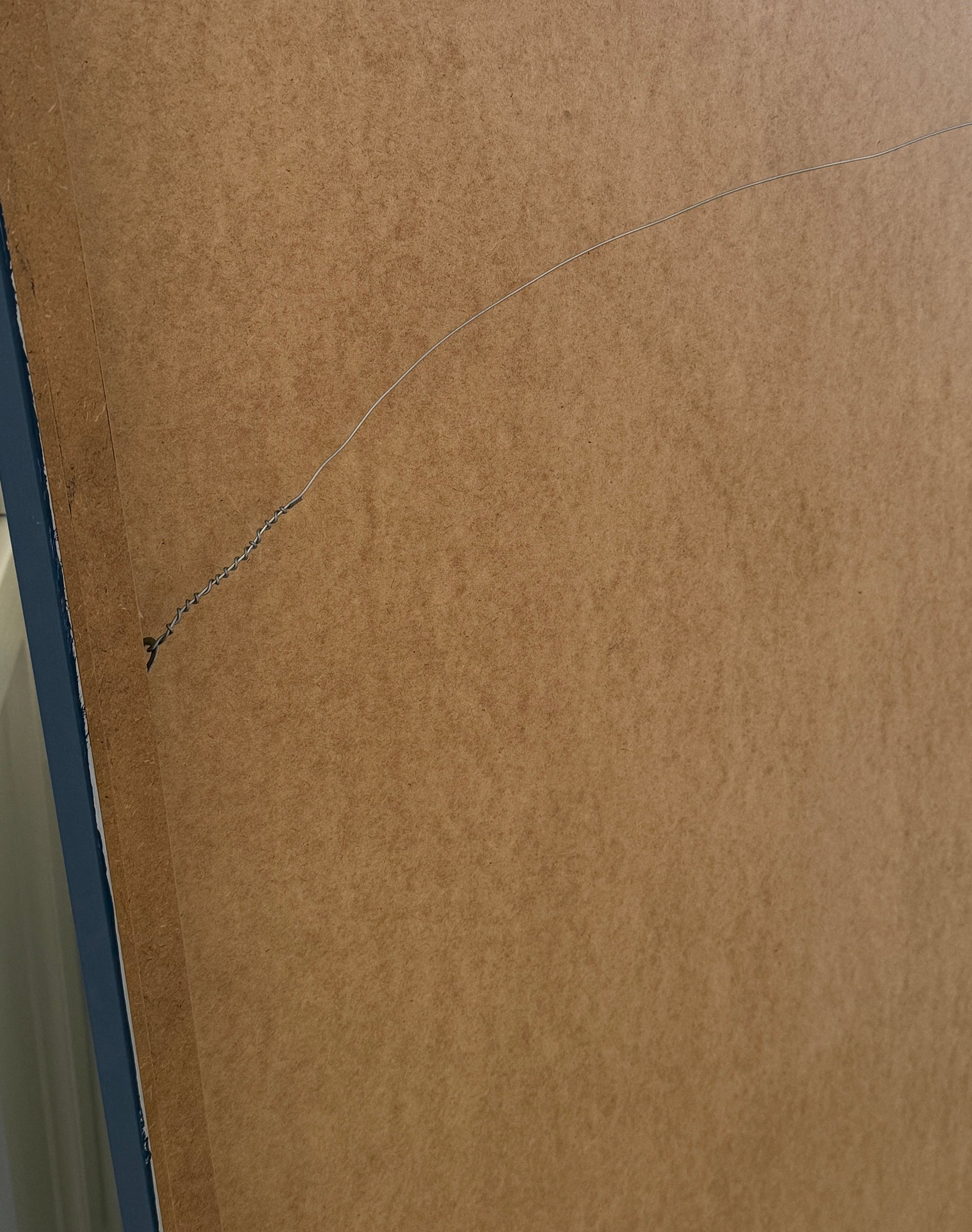 Hardware on backside of velvet acoustic wall panel