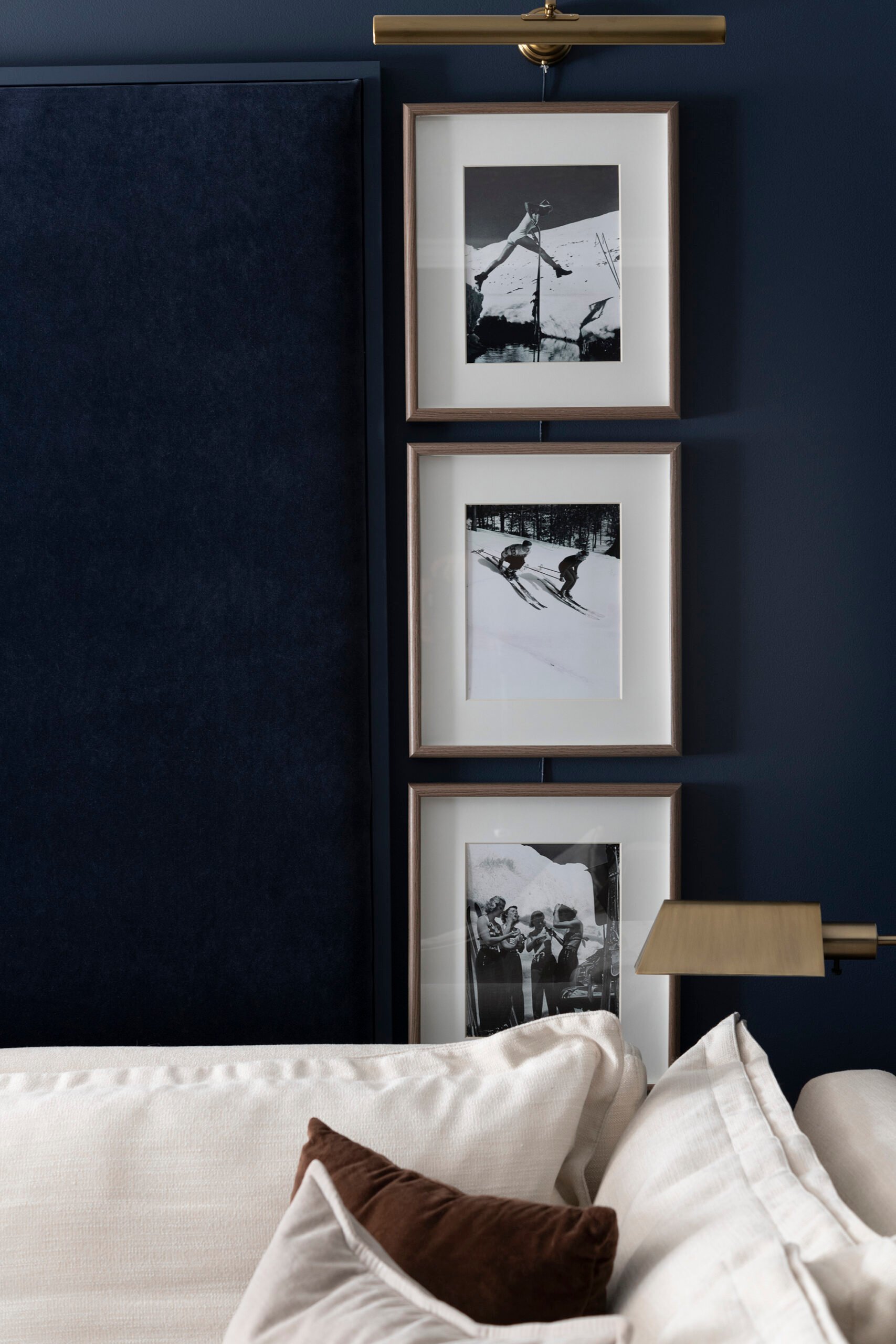 Navy blue velvet acoustic wall panel installed by vintage ski art in media room