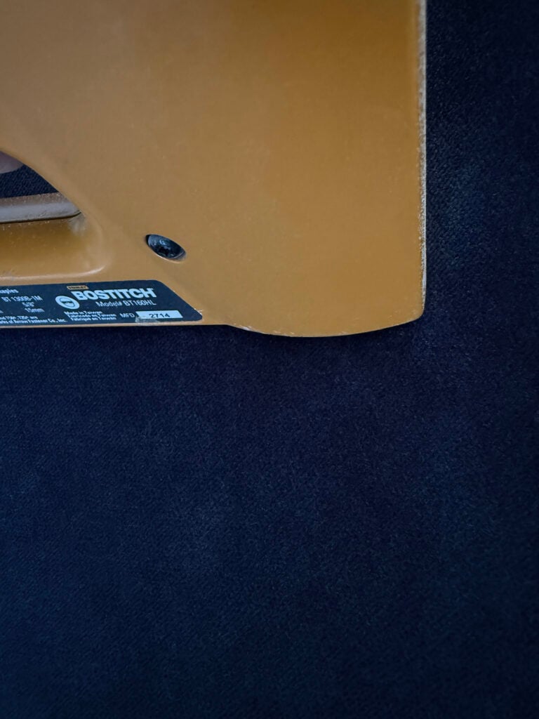 Upholstering navy velvet fabric with a staple gun