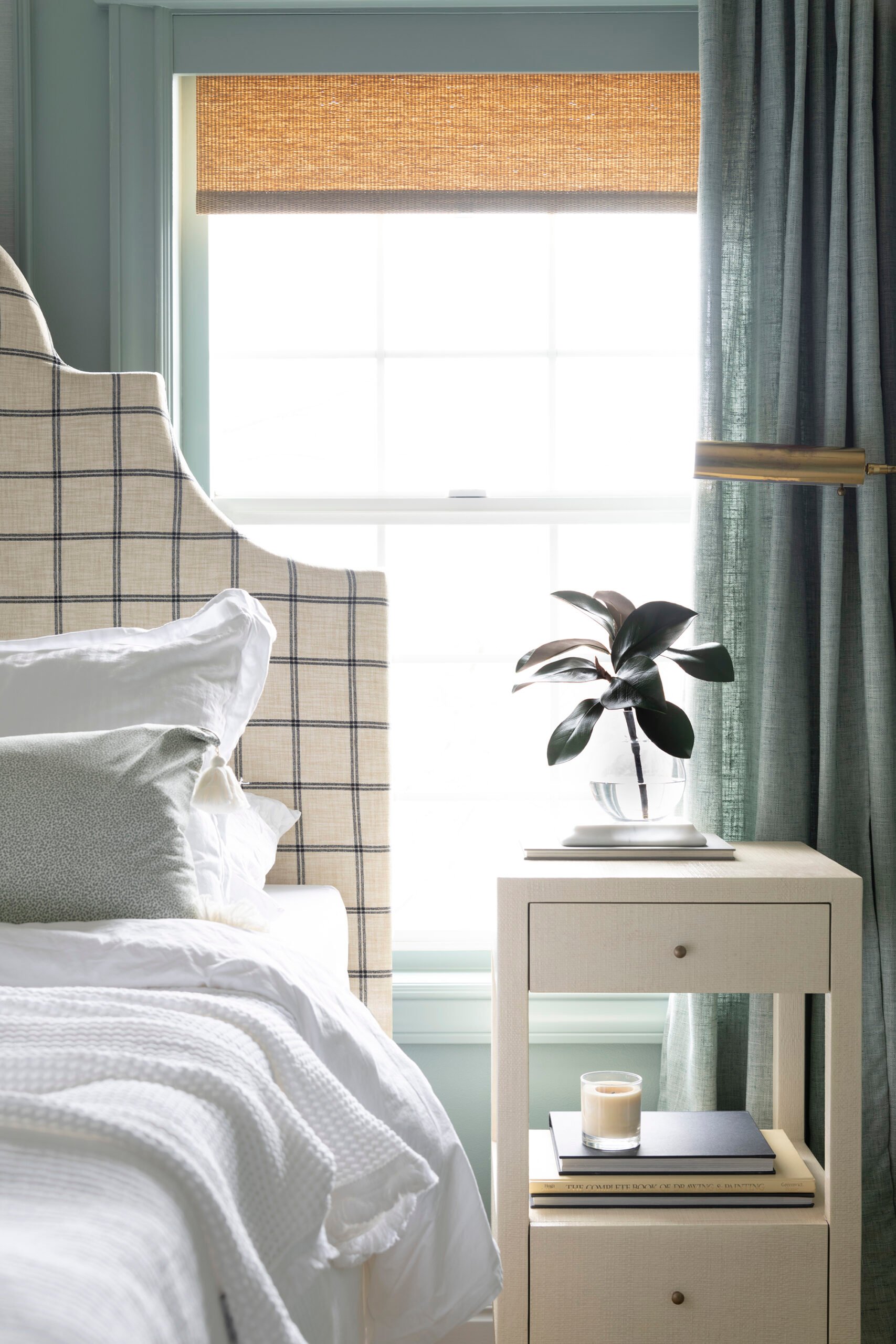 Windowpane bed frame with bedisde table in front of bedroom window
